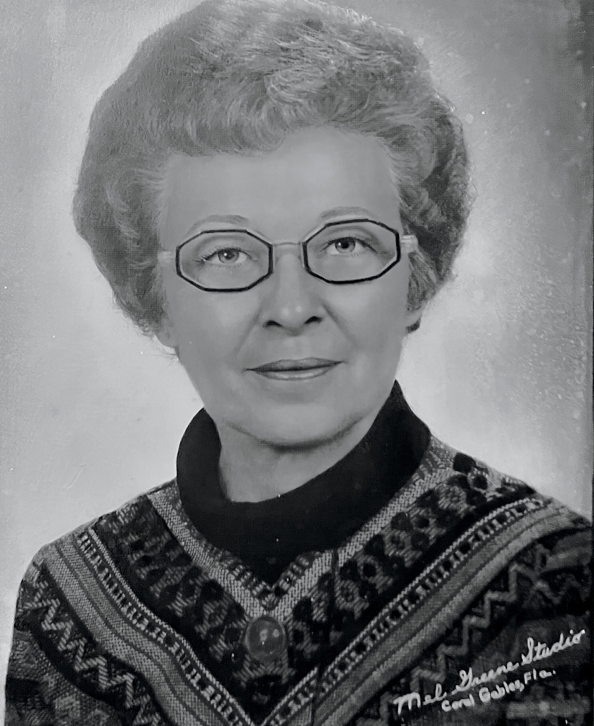 Portrait of Rebyl Zain wearing glasses and a patterned sweater, taken at a Coral Gables photography studio in the 1960s.